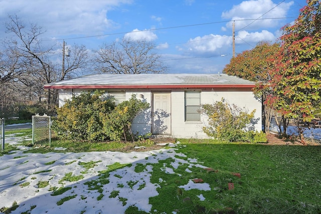 back of property featuring a lawn