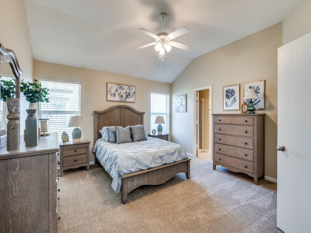 bedroom featuring multiple windows, light colored carpet, ceiling fan, and lofted ceiling