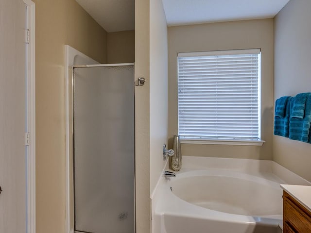 bathroom with vanity and plus walk in shower