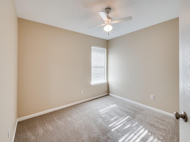 unfurnished room featuring carpet flooring and a textured ceiling