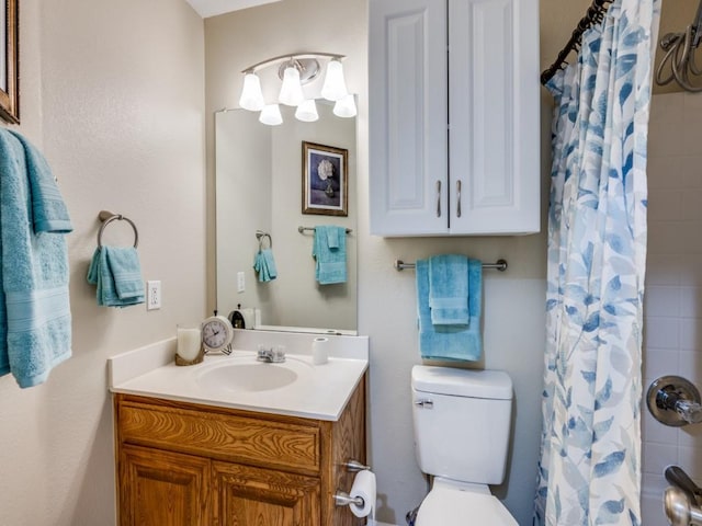 bathroom featuring vanity, a shower with shower curtain, and toilet