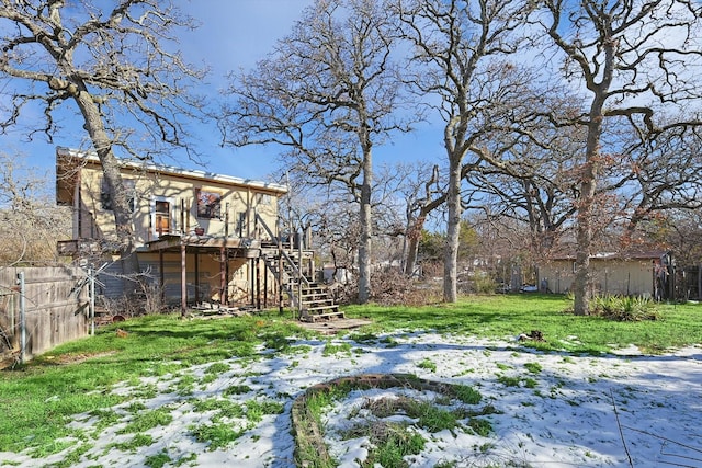 snowy yard with a deck