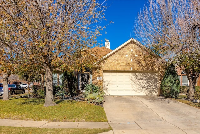 view of front of home featuring a garage and a front yard