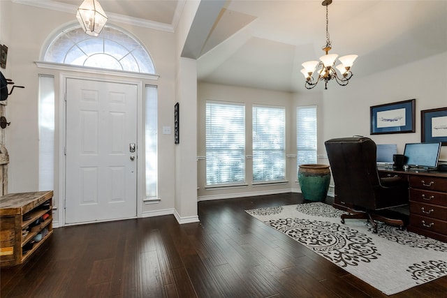 entryway featuring dark hardwood / wood-style flooring, ornamental molding, a wealth of natural light, and an inviting chandelier