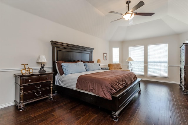 bedroom with a raised ceiling, ceiling fan, dark hardwood / wood-style flooring, and lofted ceiling