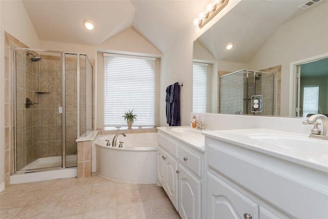 bathroom featuring tile patterned flooring, vanity, vaulted ceiling, and plus walk in shower