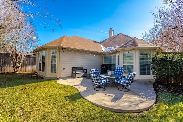 rear view of property featuring a patio and a lawn