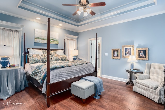 bedroom with a raised ceiling, ceiling fan, crown molding, and dark hardwood / wood-style floors