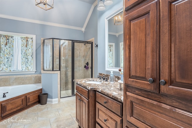 bathroom with plus walk in shower, an inviting chandelier, vaulted ceiling, vanity, and ornamental molding