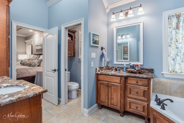 bathroom featuring tile patterned flooring, a bath, toilet, vanity, and ornamental molding