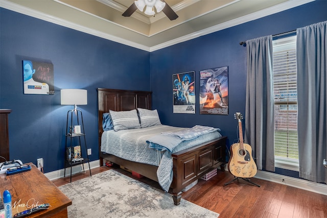 bedroom with ceiling fan, dark wood-type flooring, and ornamental molding