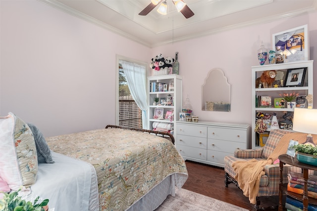 bedroom with hardwood / wood-style floors, a raised ceiling, ceiling fan, and crown molding