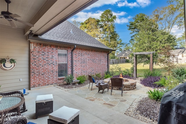 view of patio featuring ceiling fan, area for grilling, and an outdoor fire pit