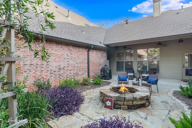 view of patio with an outdoor fire pit and ceiling fan