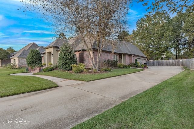 view of front of house with a garage and a front lawn