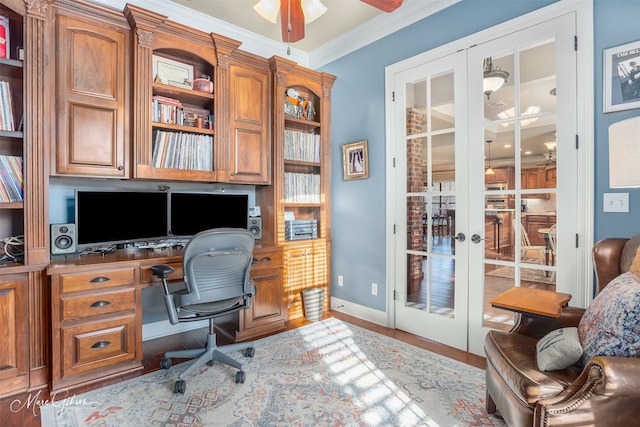 office space featuring ceiling fan, french doors, wood-type flooring, built in desk, and ornamental molding