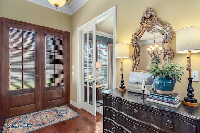 foyer entrance featuring crown molding, french doors, dark hardwood / wood-style floors, and a notable chandelier