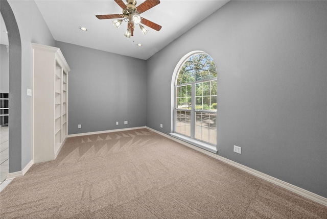 spare room featuring ceiling fan and light colored carpet