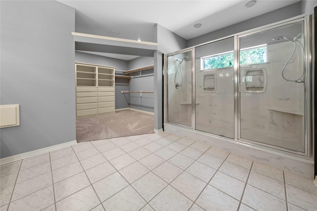 bathroom featuring tile patterned floors and a shower with door