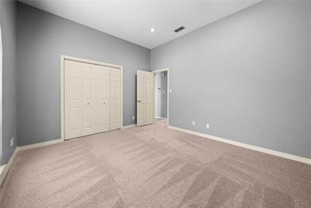 unfurnished bedroom featuring carpet flooring and a closet