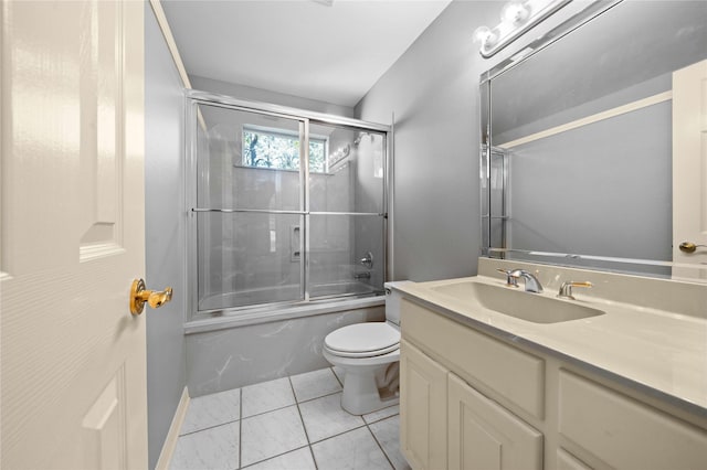 full bathroom featuring tile patterned floors, toilet, vanity, and combined bath / shower with glass door