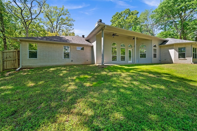 back of property with a lawn and ceiling fan