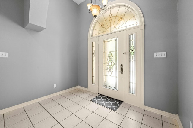 tiled entrance foyer featuring a chandelier