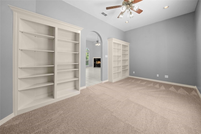 carpeted empty room featuring ceiling fan