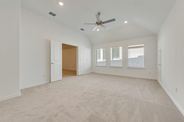 carpeted empty room with ceiling fan and lofted ceiling