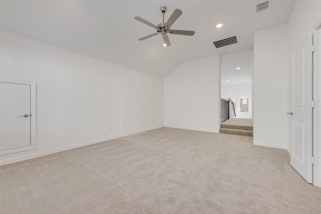 empty room featuring light carpet, ceiling fan, and lofted ceiling