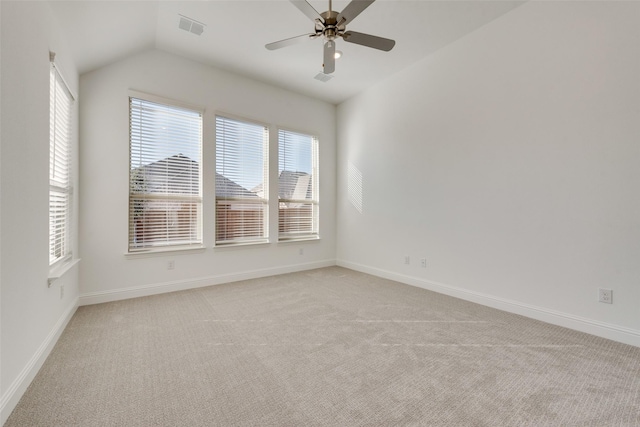 unfurnished room with light carpet, vaulted ceiling, and ceiling fan