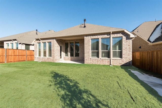 back of property featuring a patio area and a yard