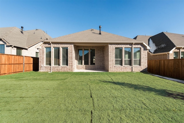 rear view of property with a patio area and a yard