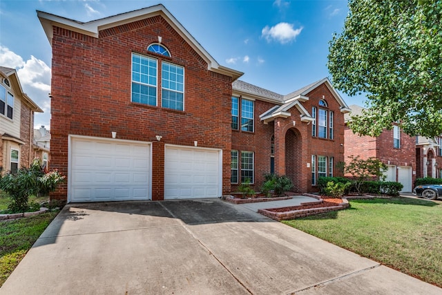 view of property featuring a front yard and a garage