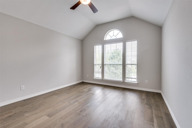 unfurnished room featuring hardwood / wood-style floors, ceiling fan, and vaulted ceiling