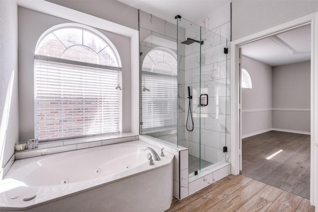 bathroom featuring separate shower and tub and hardwood / wood-style floors