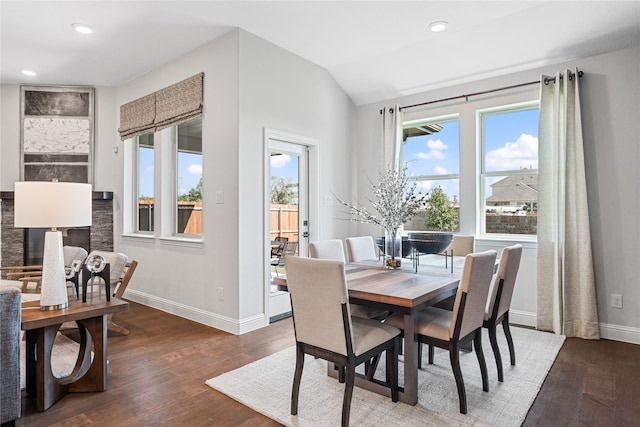 dining space with hardwood / wood-style flooring and vaulted ceiling