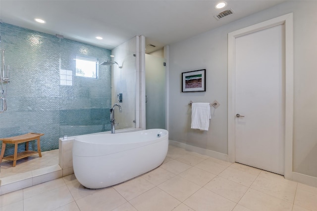 bathroom with tile patterned floors and shower with separate bathtub