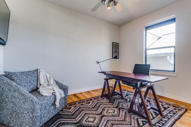 office with hardwood / wood-style flooring and ceiling fan