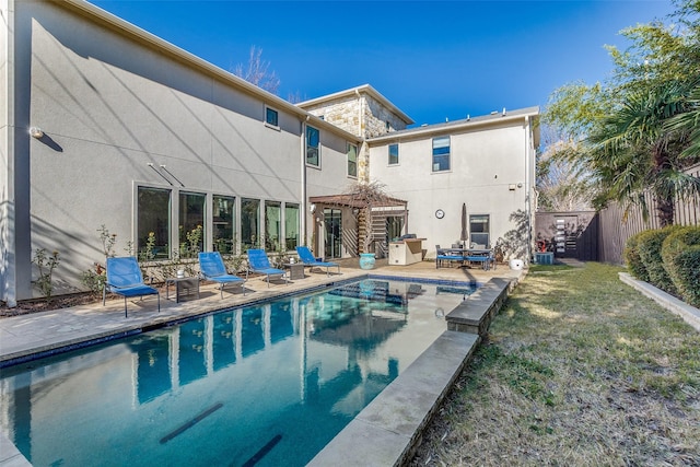 back of property featuring a gazebo, a fenced in pool, a yard, and a patio