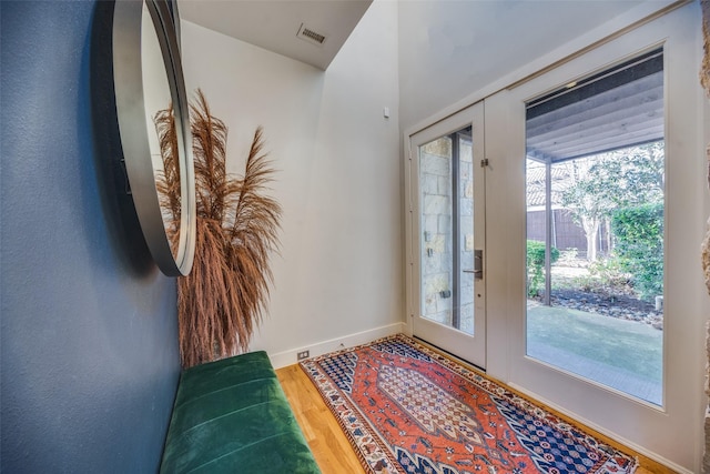 doorway with french doors and hardwood / wood-style flooring