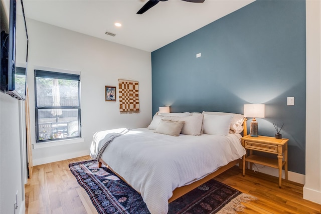 bedroom with ceiling fan and light hardwood / wood-style flooring