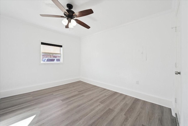 spare room featuring hardwood / wood-style flooring, ceiling fan, and ornamental molding