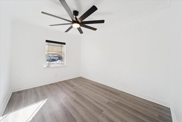 spare room with wood-type flooring, ceiling fan, and crown molding