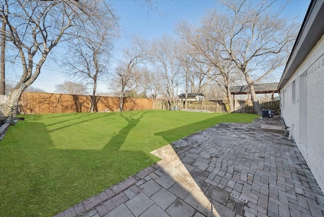 view of yard featuring a patio area and central air condition unit