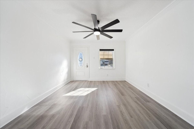 spare room featuring ceiling fan, light hardwood / wood-style flooring, and ornamental molding