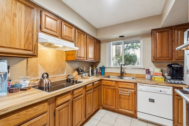9728 Amberton Pkwy, Dallas, TX 75243 - kitchen with dishwasher, under cabinet range hood, a sink, black electric cooktop, and brown cabinetry