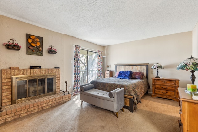 carpeted bedroom with a textured ceiling, a fireplace, and access to outside