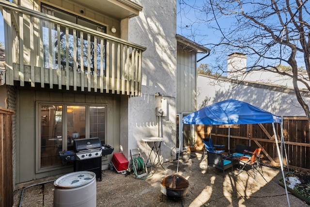 9728 Amberton Pkwy, Dallas, TX 75243 - rear view of house featuring a balcony, a patio area, a chimney, and a fire pit