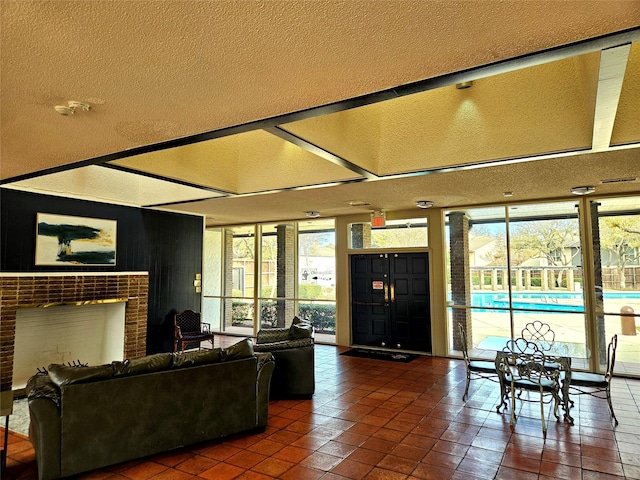 9728 Amberton Pkwy, Dallas, TX 75243 - tiled living area featuring a brick fireplace, expansive windows, and a textured ceiling